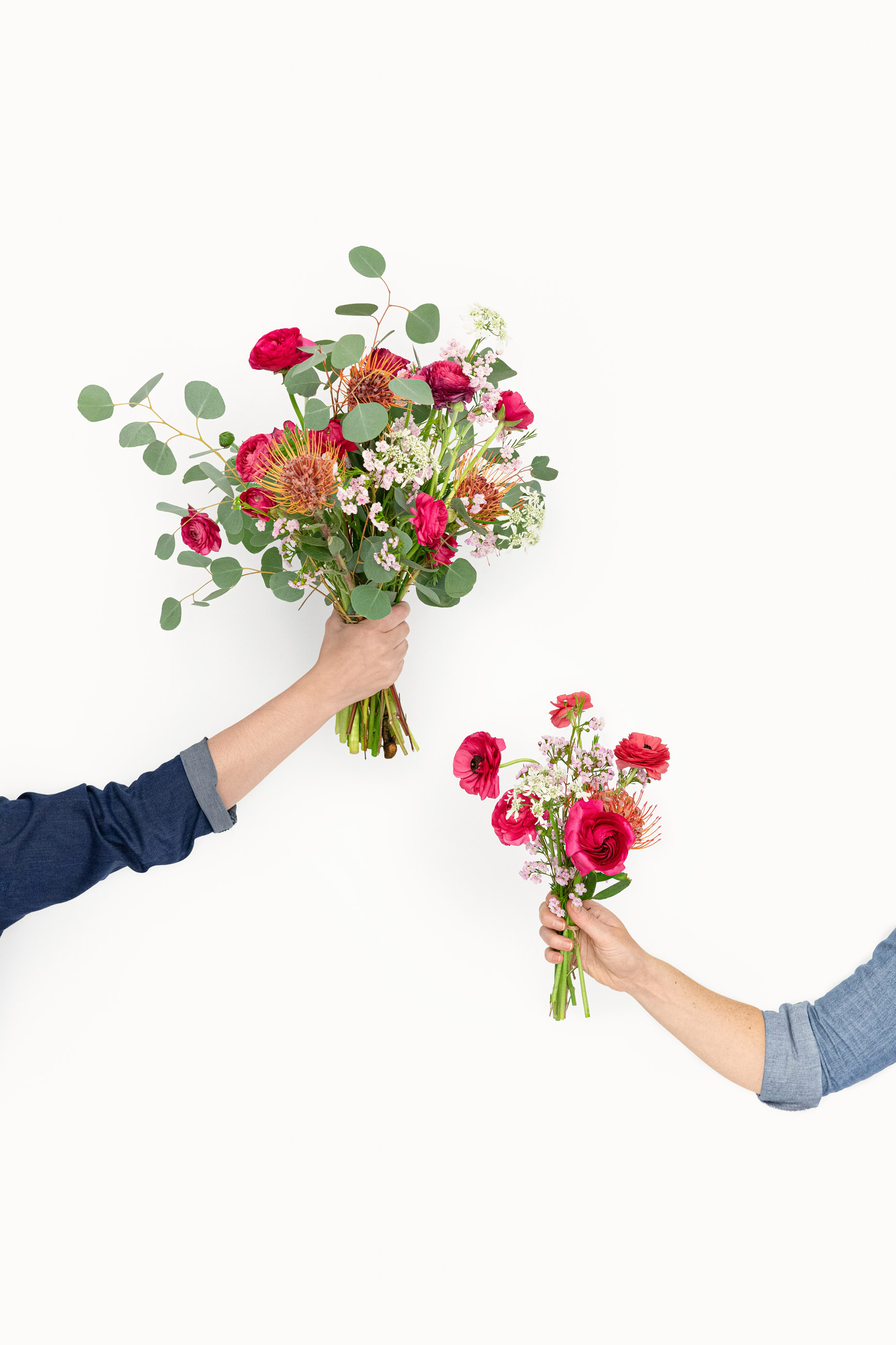 Hands holding flowers vibrant flower arrangements